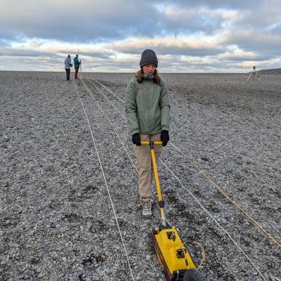 student operating ground radar on a beach 